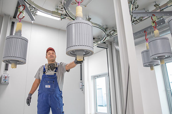 Employee with TSA products in painting booth during surface coating