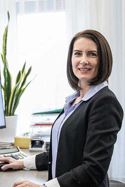 TSA employee standing in front of computer in office